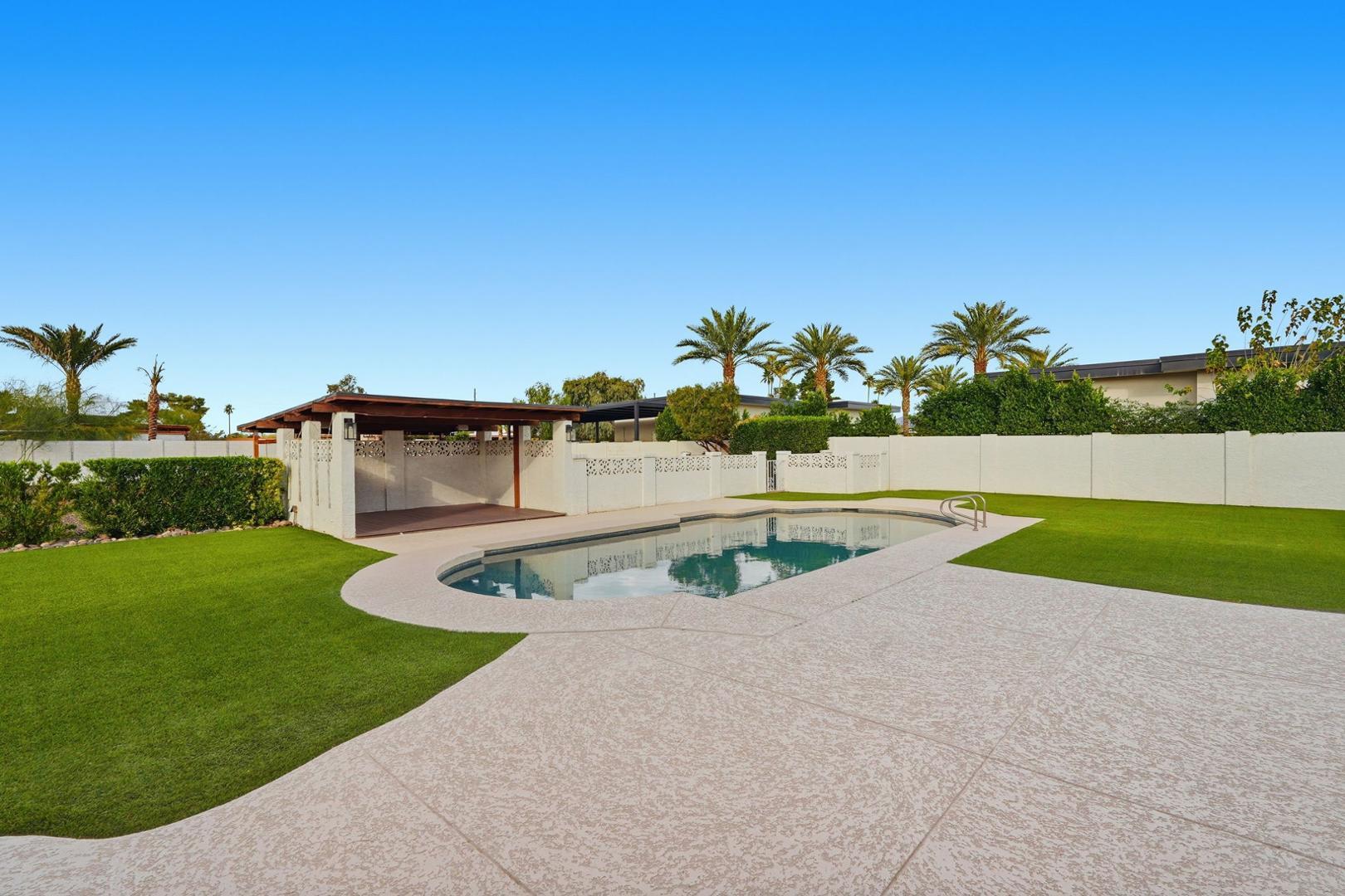 6302 East Cochise Road Paradise Valley, AZ 85253 - Photo 46 of 58 a view of a swimming pool with a yard