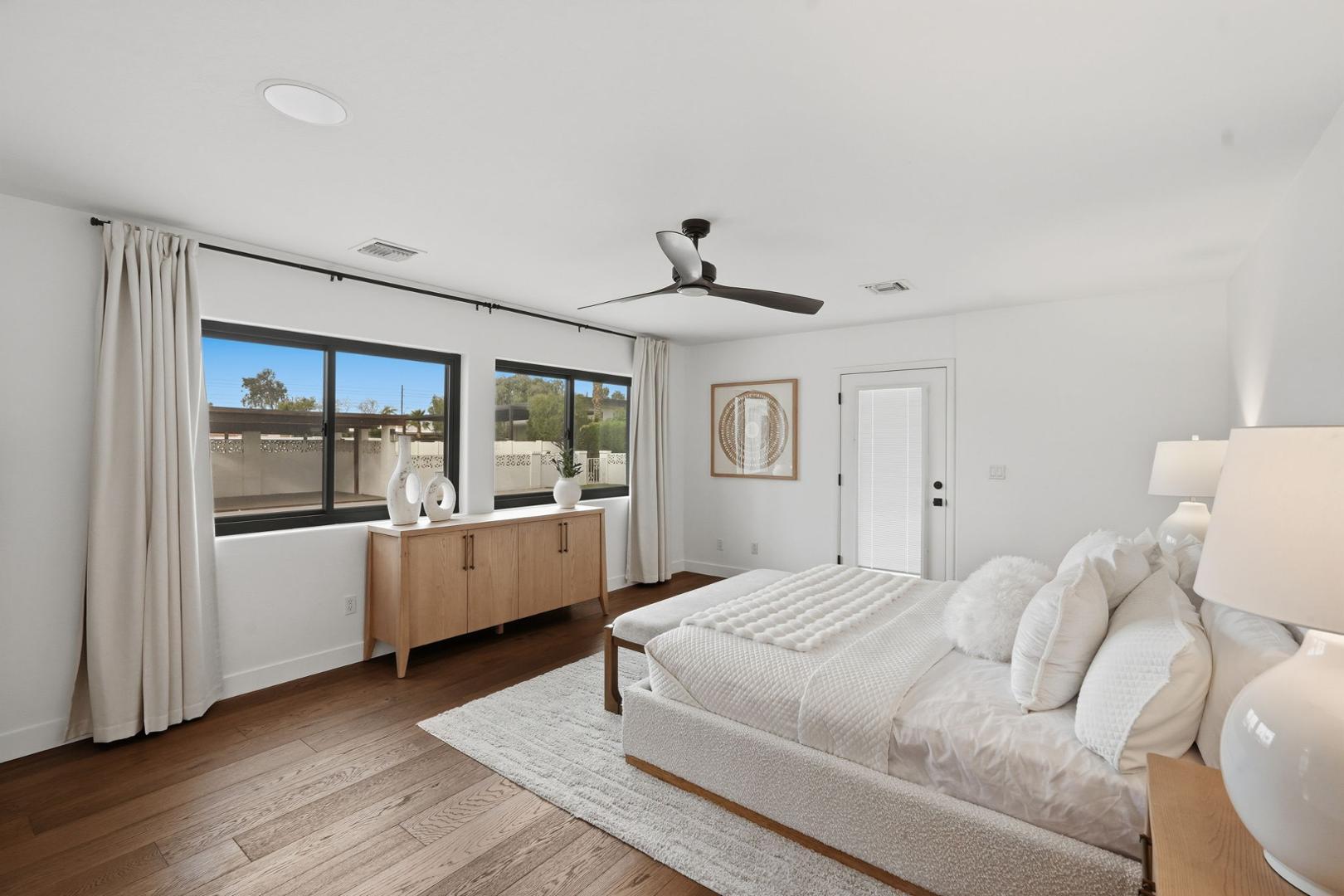 6302 East Cochise Road Paradise Valley, AZ 85253 - Photo 54 of 58 a bedroom with a white bed with wooden floors