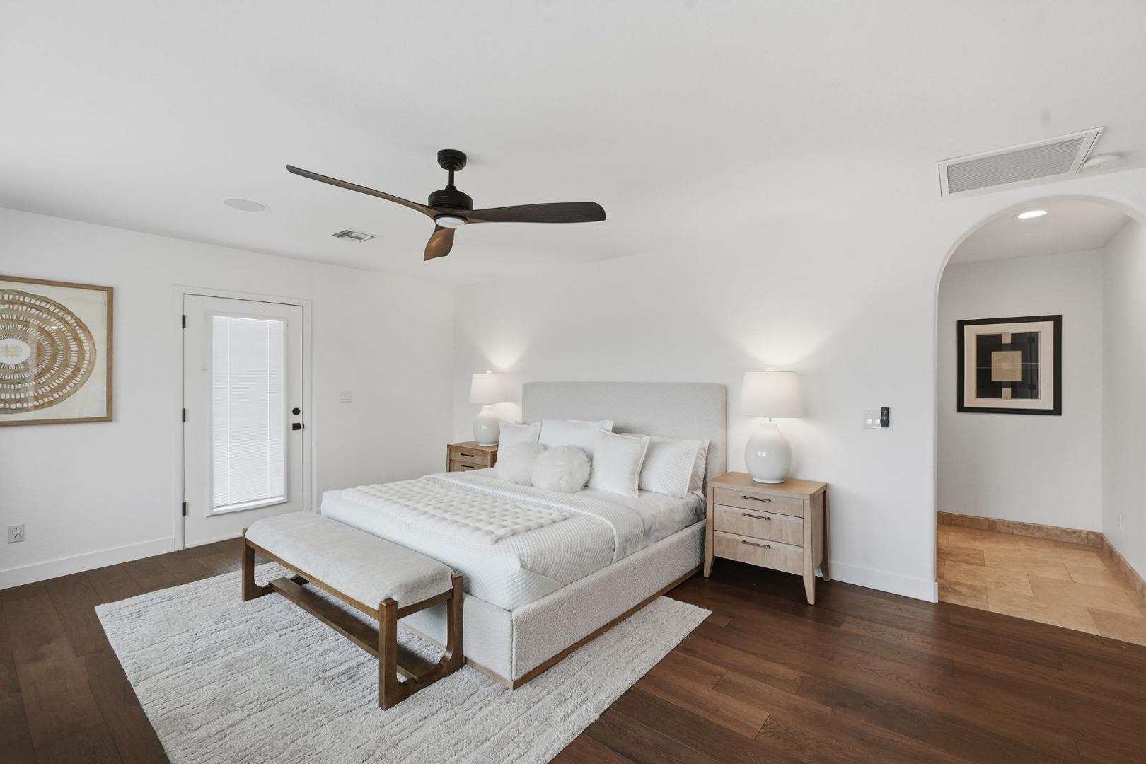 6302 East Cochise Road Paradise Valley, AZ 85253 - Photo 9 of 58 a spacious bedroom with a bed and a chandelier