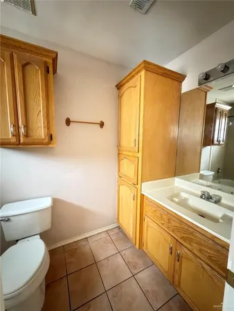 a bathroom with a sink a toilet and mirror