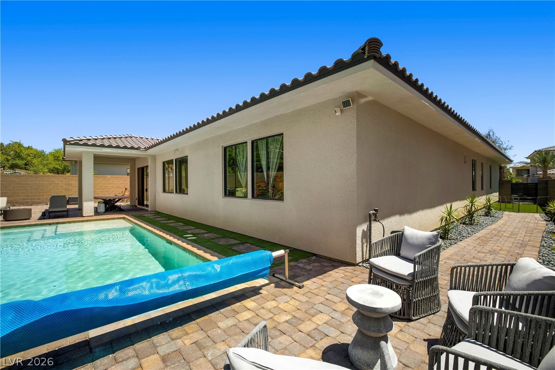 45 Garibaldi Way Henderson, NV 89011 - Photo 36 of 74 An inviting pool area with stone-paved patio offers abundant space for leisure and outdoor enjoyment.
