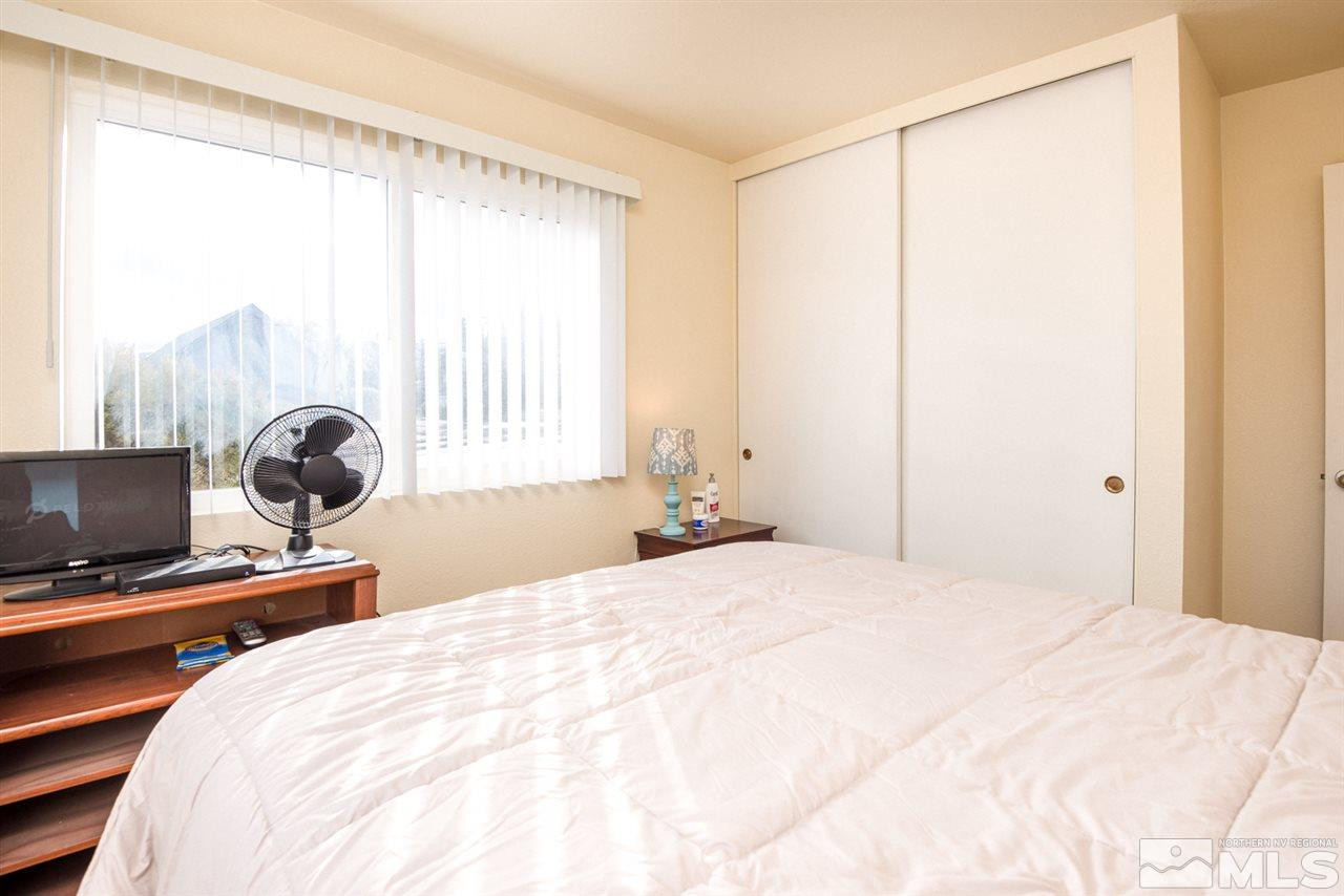2401 West 7th Street Reno, NV 89503 - Photo 18 of 24 a bedroom with a bed and a chair
