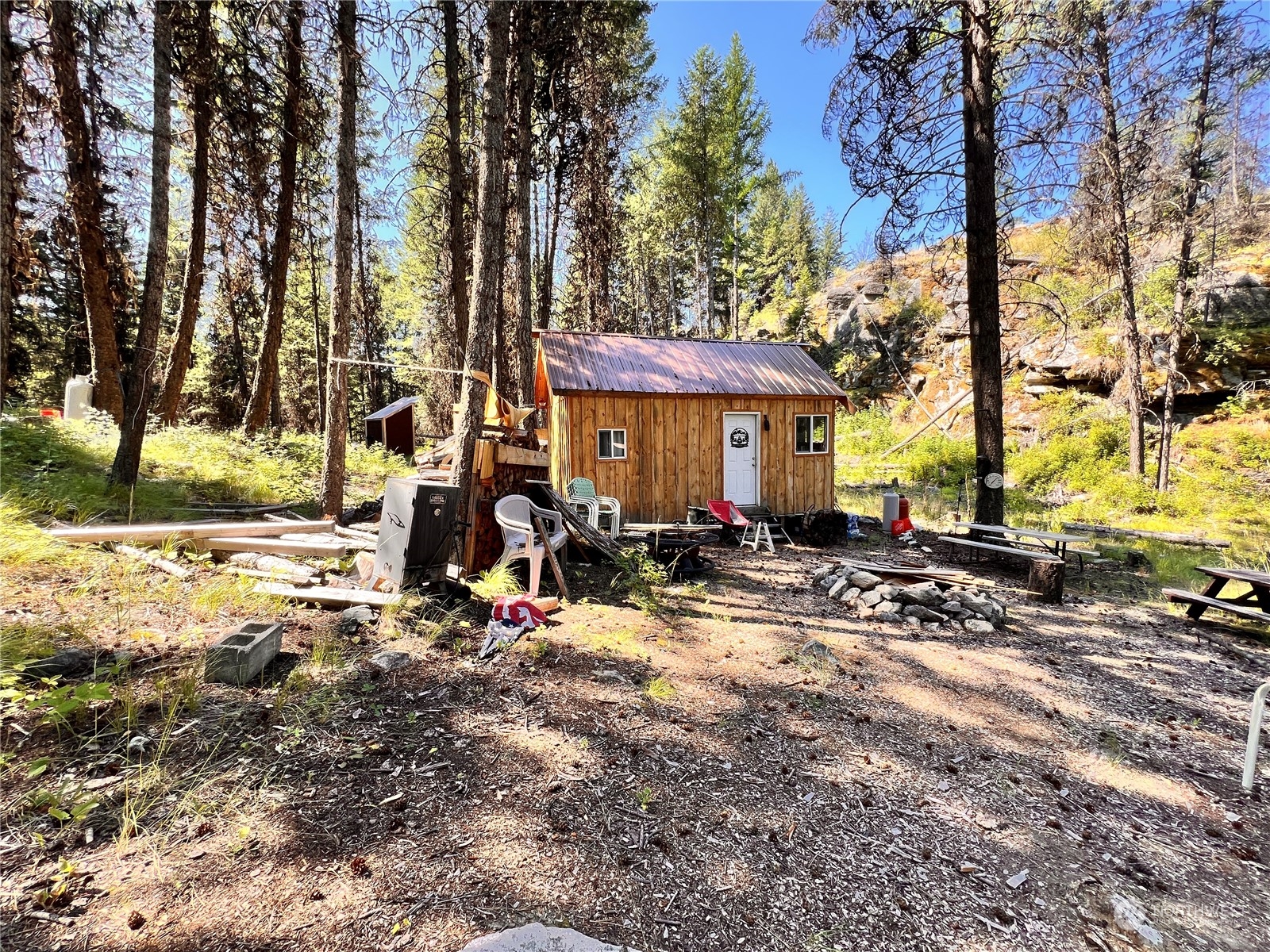 40 Excelsior Way Curlew, WA 99118 - Photo 13 of 20 a view of a house with large trees and sitting area