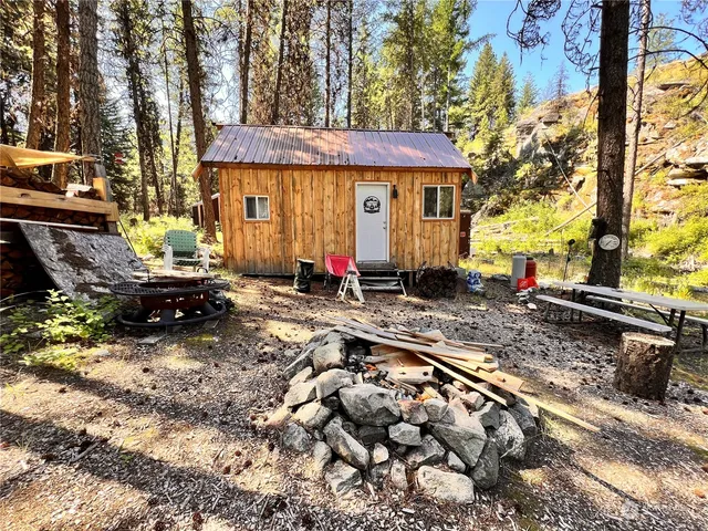 a view of a chairs and table in the backyard