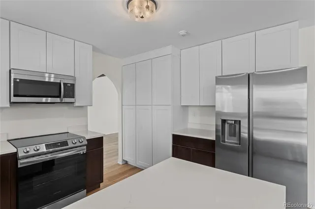 a kitchen with stainless steel appliances a refrigerator a stove and a sink