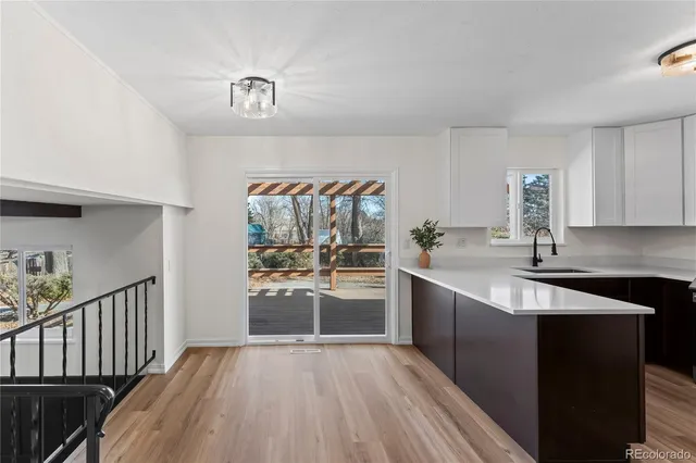 a kitchen with granite countertop a refrigerator and a sink