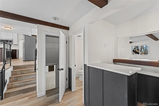 a hallway with cabinets and wooden floor