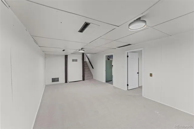 a view of an empty room with a white walls