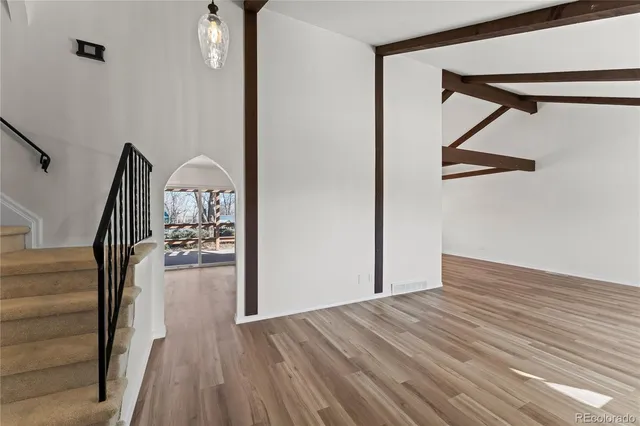 a view of entryway and hall with wooden floor