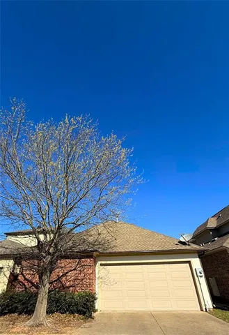a view of a house with a tree