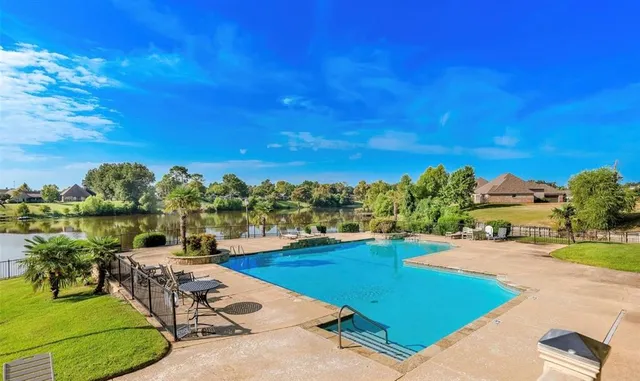 a view of a swimming pool with an outdoor seating and a yard