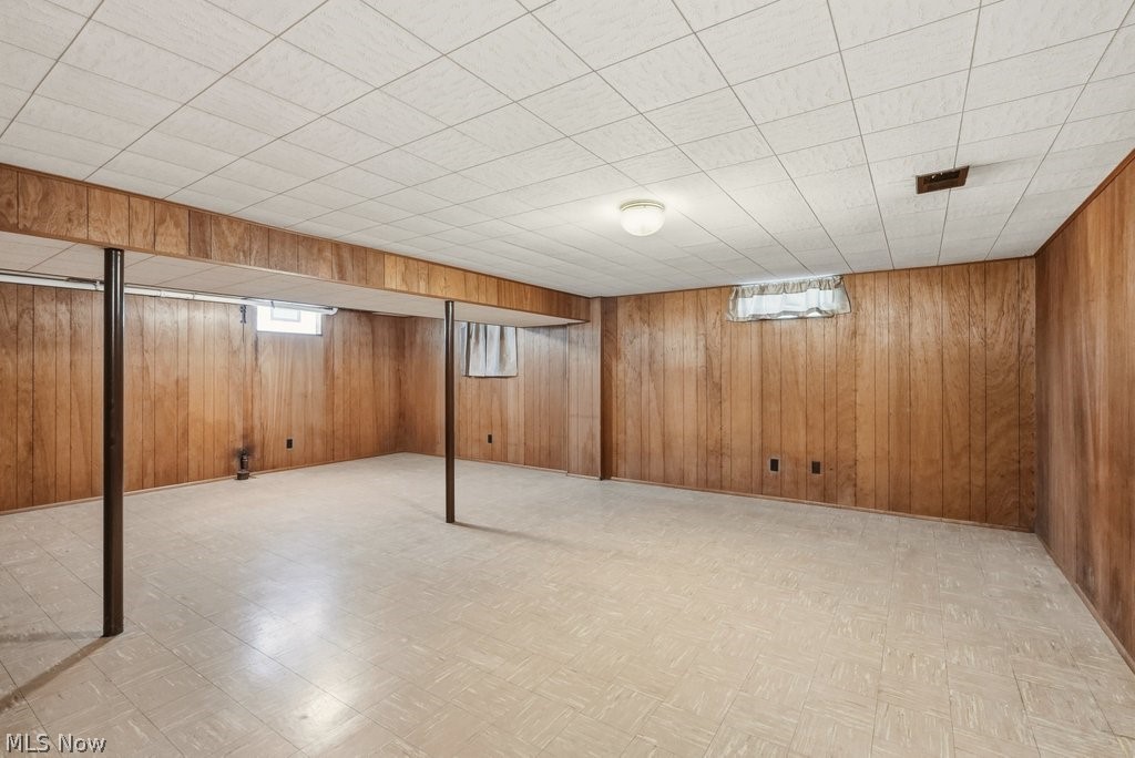 161 Pinehurst Road Munroe Falls, OH 44262 - Photo 28 of 40 Spacious finished lower level featuring wood-paneled walls and a grid ceiling