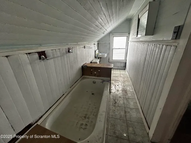 a room with water heater and wooden racks