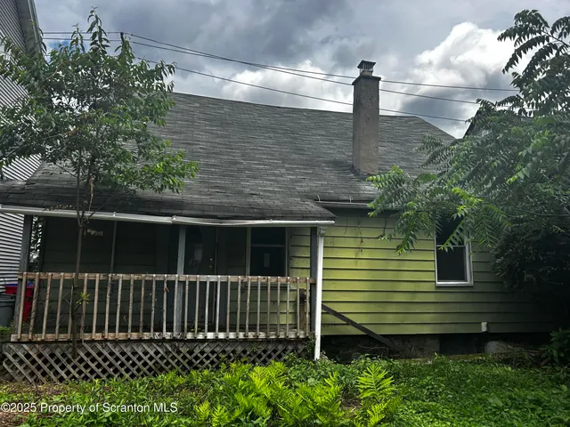 a side view of a house with a small yard