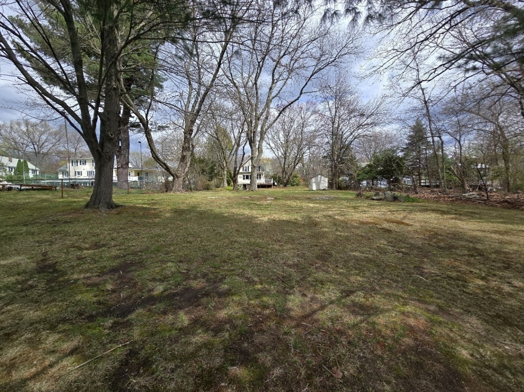 141 Westview Road Lowell, MA 01851 - Photo 22 of 39 a yard with trees in the background