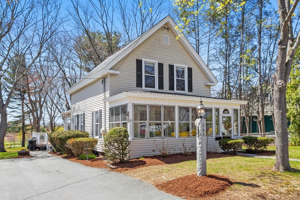 141 Westview Road Lowell, MA 01851 - Photo 29 of 39 a front view of a house with a garden and trees