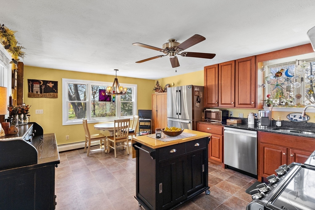 141 Westview Road Lowell, MA 01851 - Photo 5 of 39 a kitchen with stainless steel appliances granite countertop a stove top oven a sink dishwasher stove and refrigerator with wooden cabinets