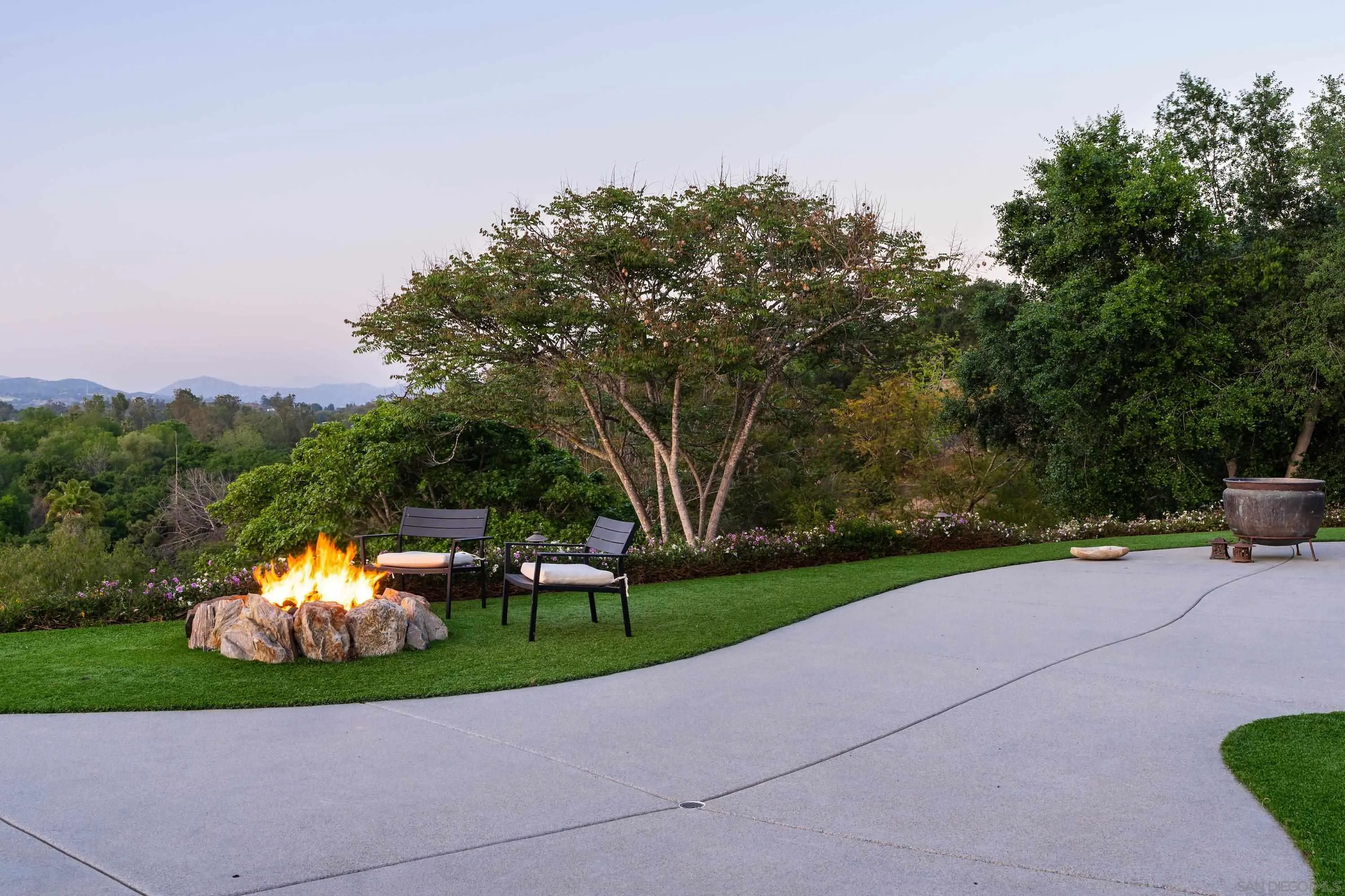 1834 Winterwarm Drive Fallbrook, CA 92028 - Photo 36 of 49 a backyard of a house with lots of green space and fountain