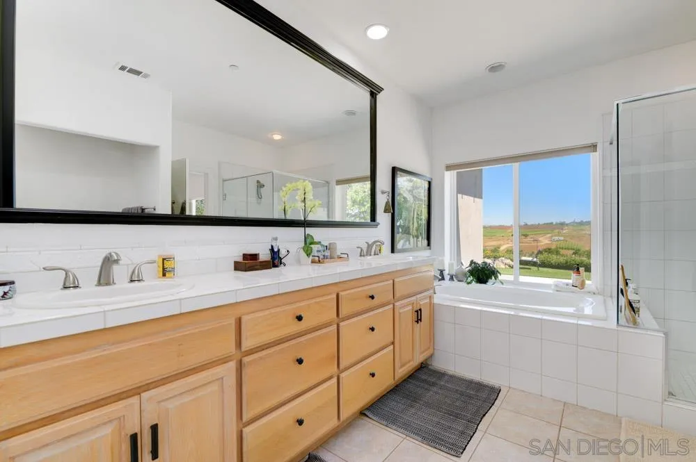 1834 Winterwarm Drive Fallbrook, CA 92028 - Photo 44 of 49 a bathroom with a granite countertop sink mirror and window