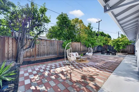 a front view of house with yard outdoor seating and barbeque oven