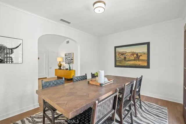a dining room with furniture and wooden floor