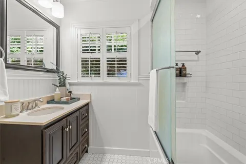 a bathroom with a sink a vanity and a bathtub