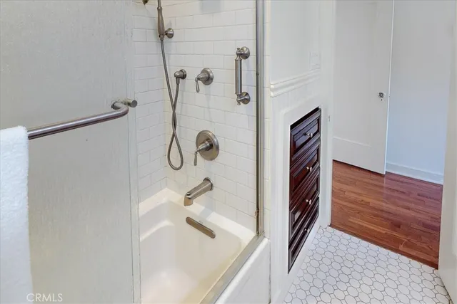 a bathroom with a bathtub and shower