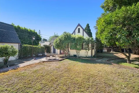 a view of a park with plants and a bench