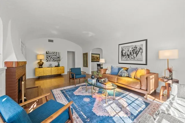 a living room with furniture and wooden floor