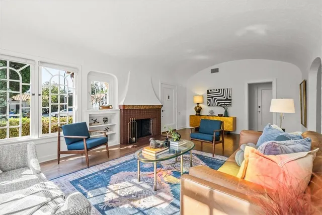 a living room with furniture fireplace and a table
