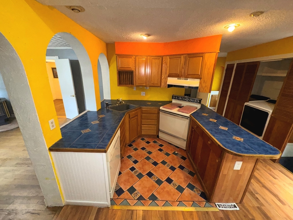37 David Street Springfield, MA 01104 - Photo 14 of 29 a kitchen with a sink stove and refrigerator