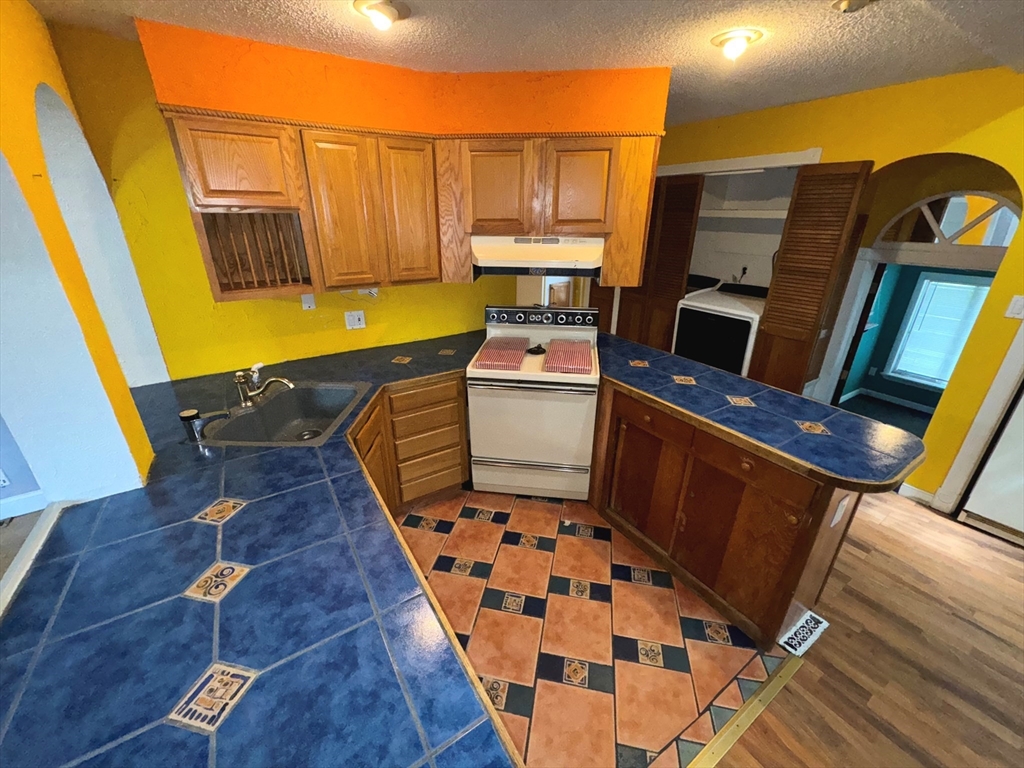 37 David Street Springfield, MA 01104 - Photo 15 of 29 a kitchen with stainless steel appliances wooden floor and a sink