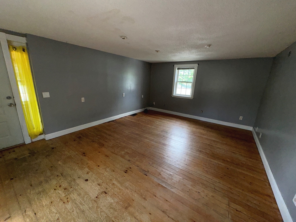 37 David Street Springfield, MA 01104 - Photo 5 of 29 a view of an empty room with wooden floor and a window