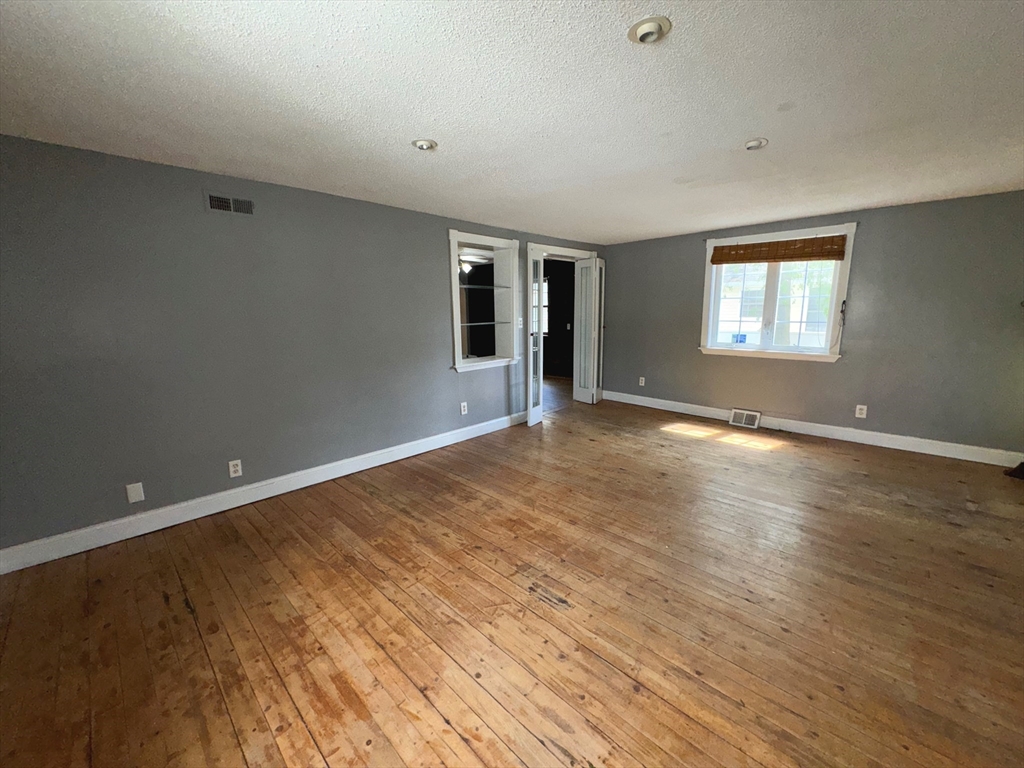 37 David Street Springfield, MA 01104 - Photo 6 of 29 a view of an empty room with wooden floor and a window