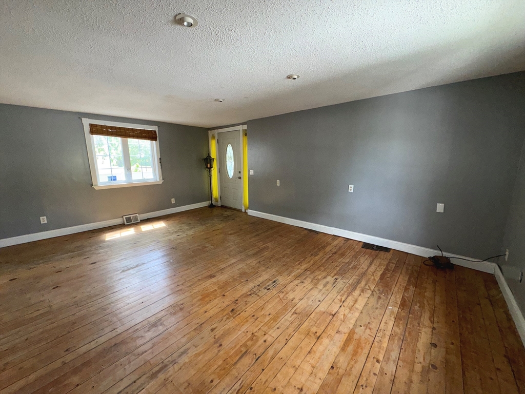 37 David Street Springfield, MA 01104 - Photo 7 of 29 an empty room with wooden floor and windows