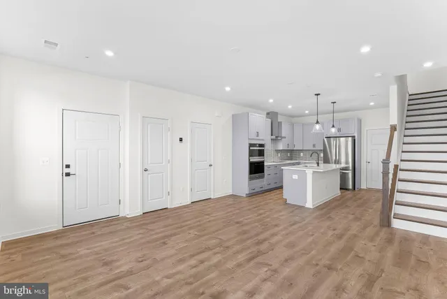 a kitchen with a sink a counter top space and cabinets