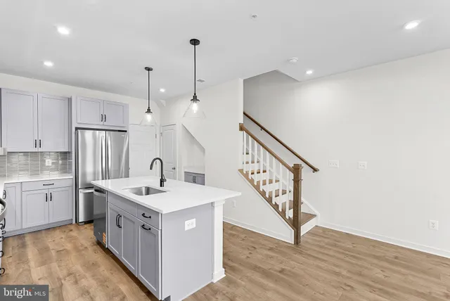 a kitchen with sink stove and window