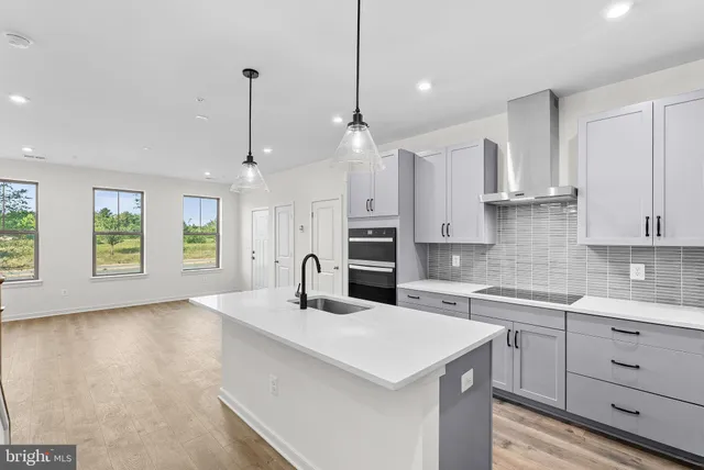 a view of a kitchen with furniture and wooden floor