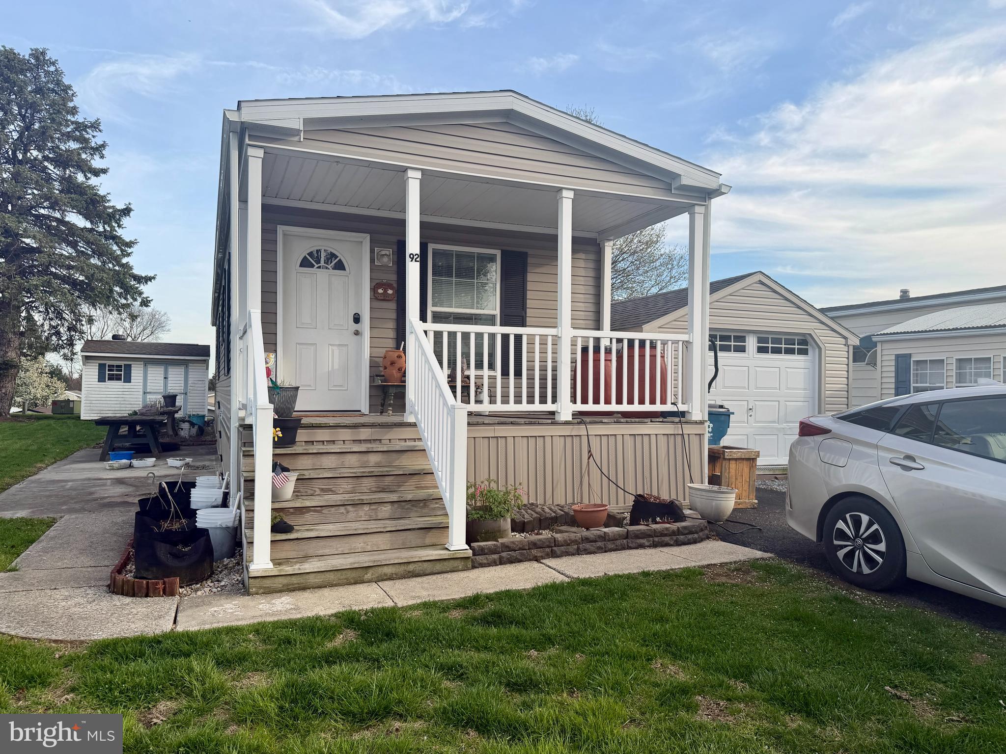 92 Ridgewood Manor Manheim, PA 17545 - Photo 2 of 22 a view of a house with a yard and lawn chairs