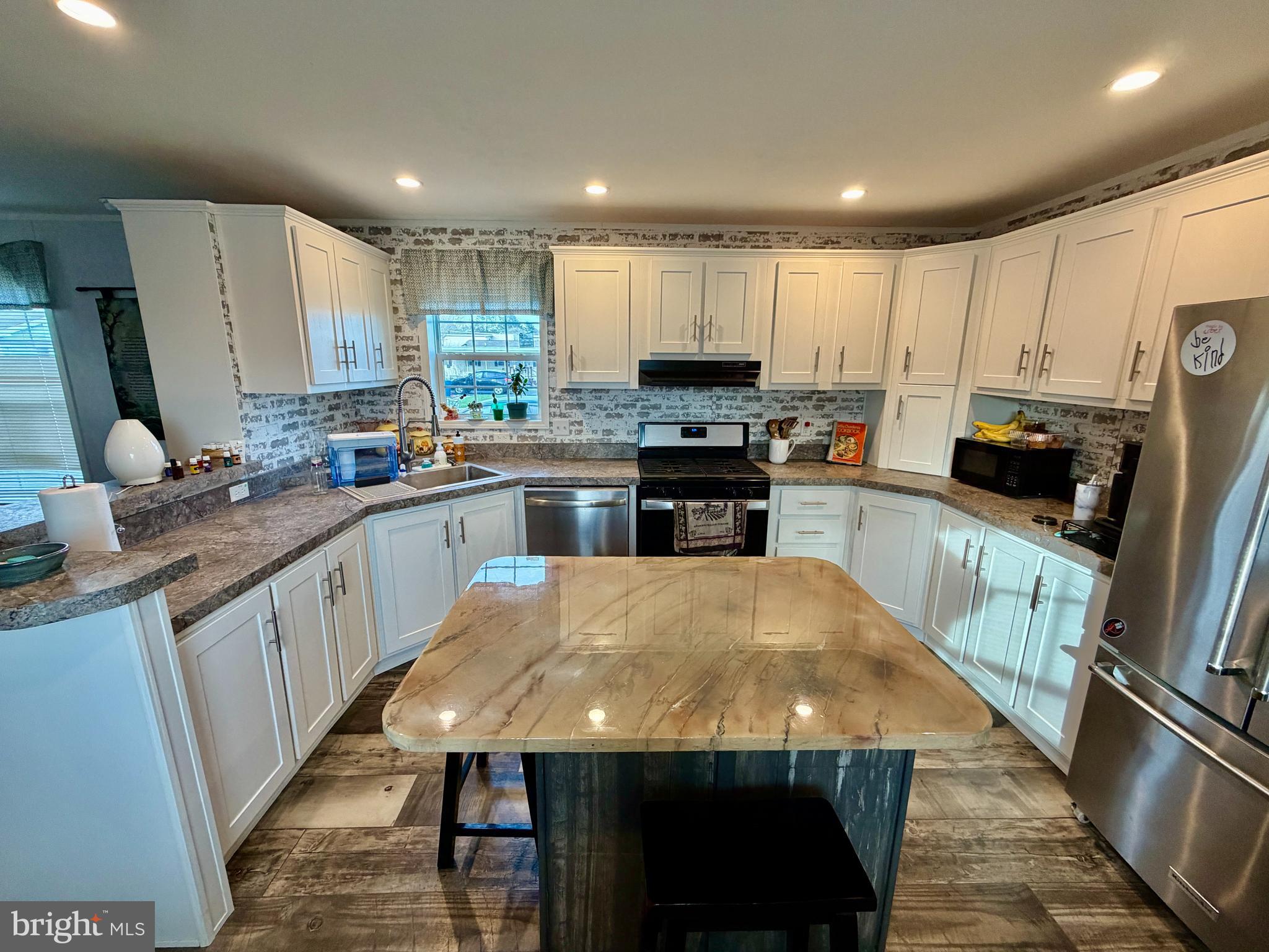 92 Ridgewood Manor Manheim, PA 17545 - Photo 9 of 22 a kitchen with stainless steel appliances granite countertop a sink microwave stove and refrigerator