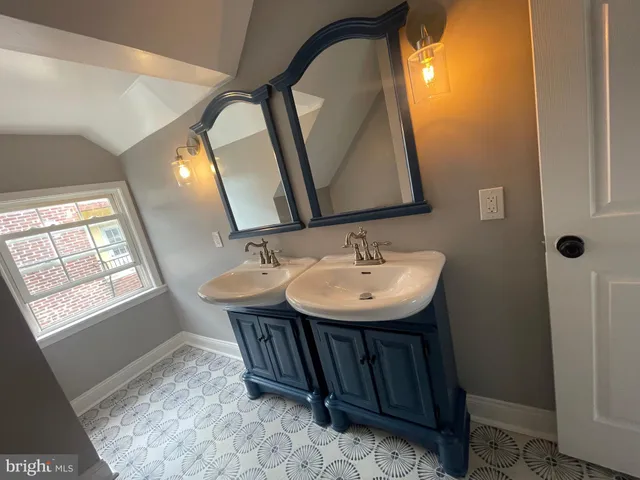 a bathroom with a sink and mirror