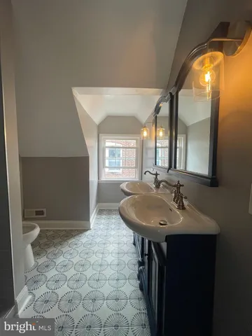 a bathroom with a sink a toilet and a mirror