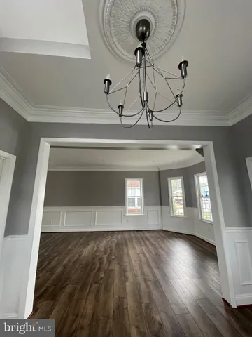 a view of room with window and wooden floor