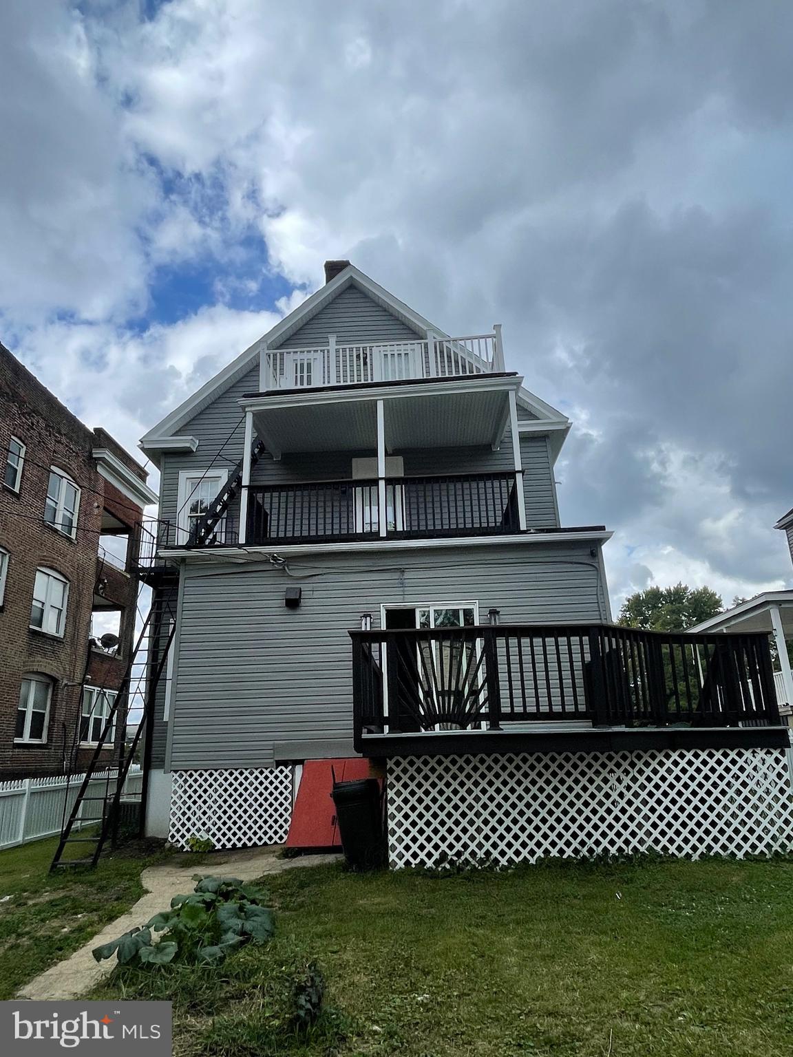 2403 Garrison Boulevard Baltimore, MD 21216 - Photo 33 of 34 a front view of a house with a yard