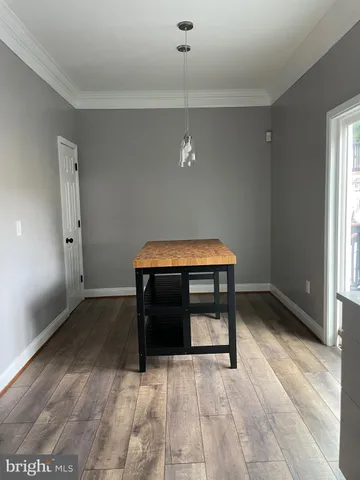 a room with wooden floor and furniture