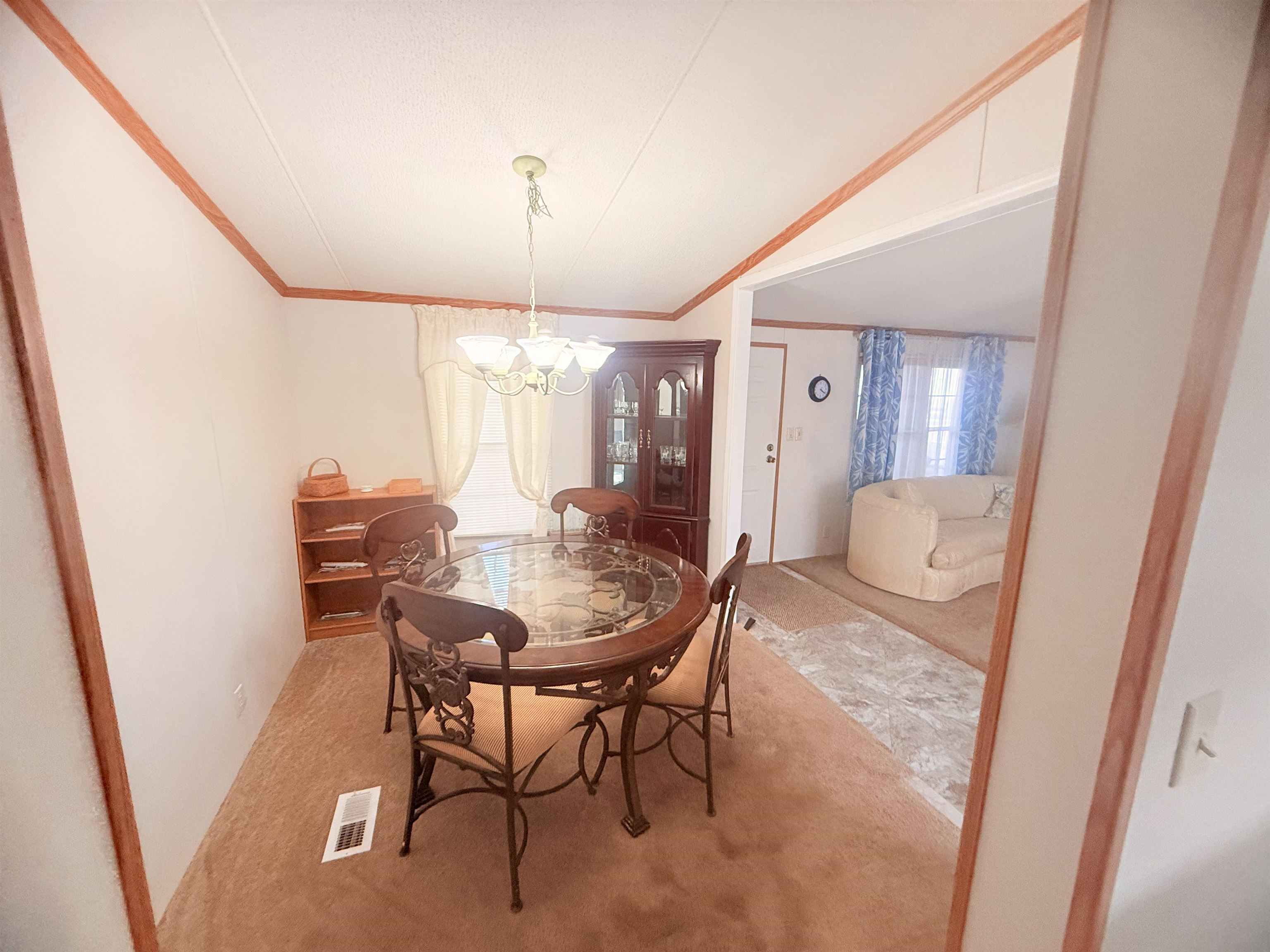 5 Buccaneer Street Murrells Inlet, SC 29576 - Photo 12 of 30 Dining space with carpet floors, ornamental molding, and a chandelier