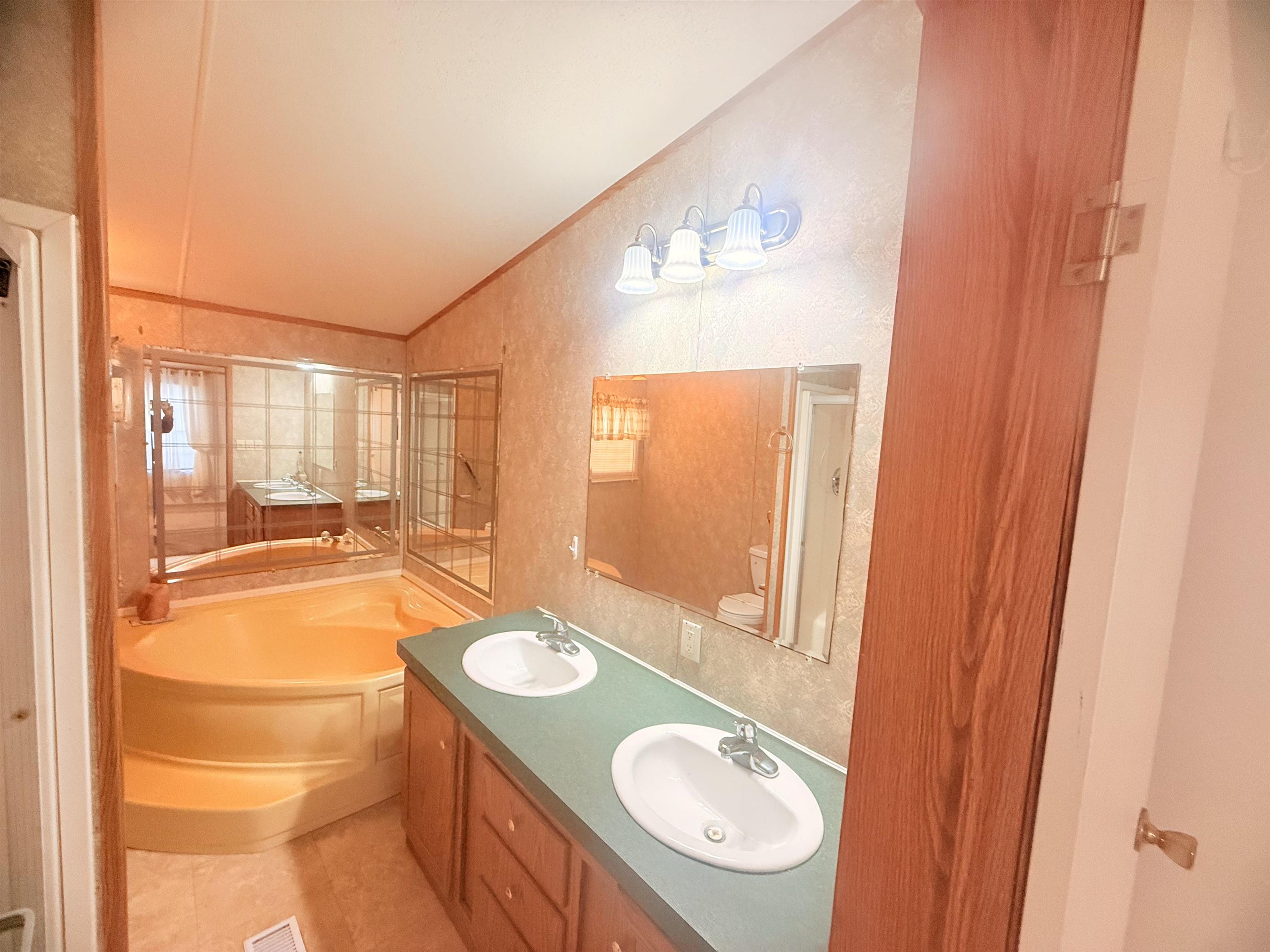 5 Buccaneer Street Murrells Inlet, SC 29576 - Photo 14 of 30 Full bath with a garden tub, double vanity, a textured wall, ornamental molding, and light tile patterned floors