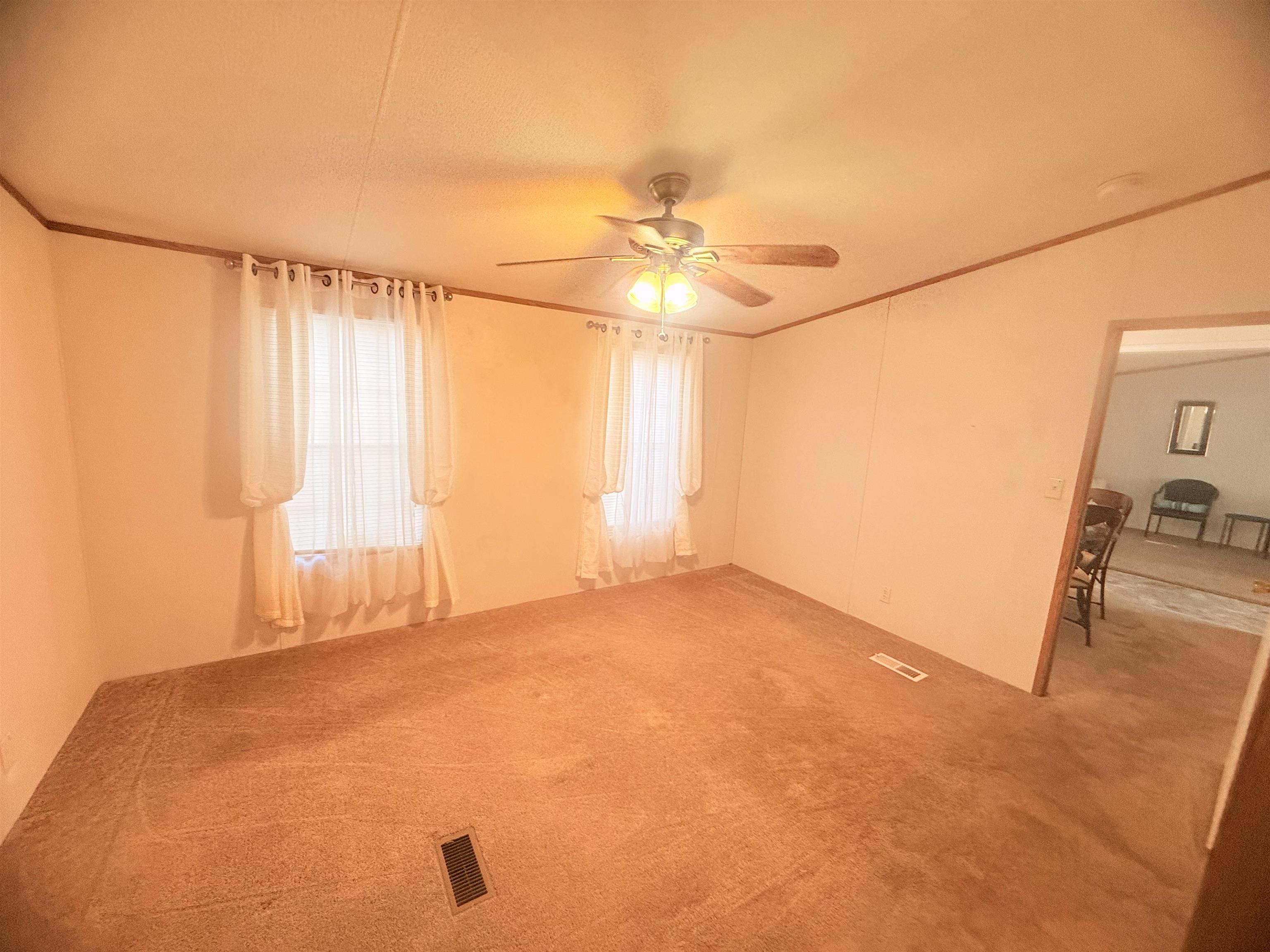 5 Buccaneer Street Murrells Inlet, SC 29576 - Photo 16 of 30 Unfurnished room with crown molding, carpet, and ceiling fan