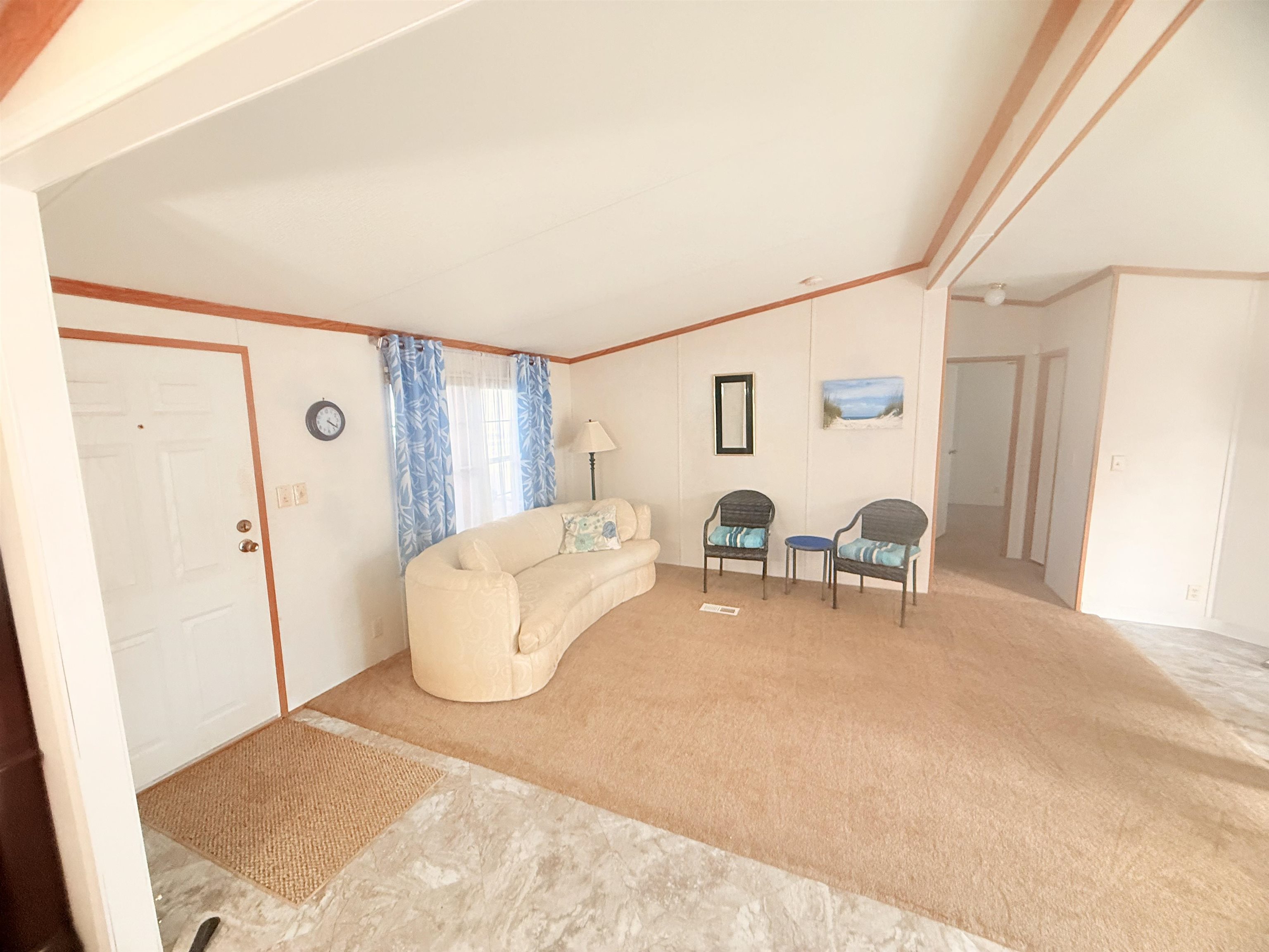 5 Buccaneer Street Murrells Inlet, SC 29576 - Photo 17 of 30 Carpeted living room with vaulted ceiling and ornamental molding