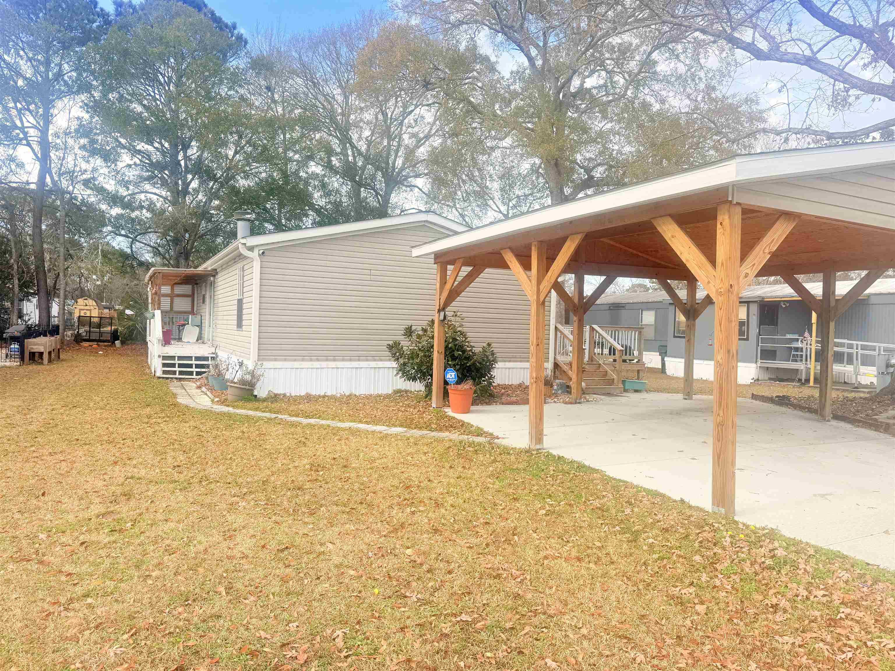 5 Buccaneer Street Murrells Inlet, SC 29576 - Photo 2 of 30 View of side of home with a yard, concrete driveway, a gazebo, and a carport
